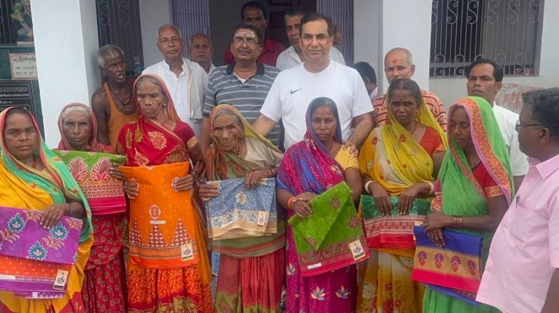 BJP leader AP Pathak distributed sarees among needy women