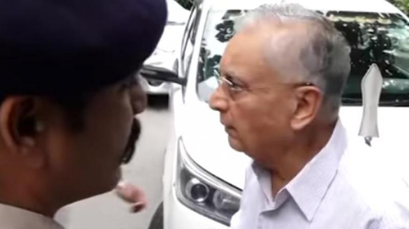 An elderly man stops Karnataka Chief Minister Siddaramaiah's car.